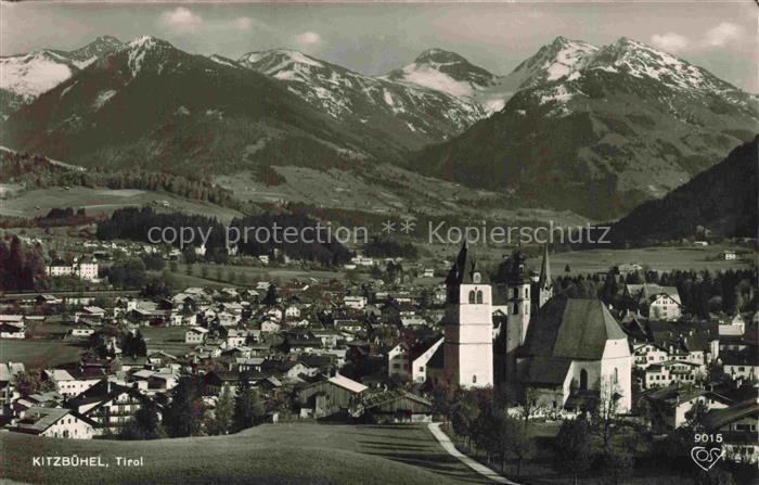 Kitzbuehel Tirol AT Kirche Alpen Schnee Daecher Wiese