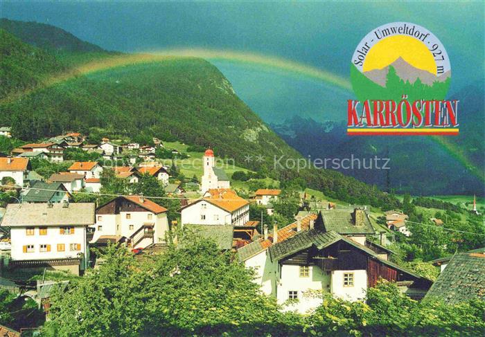 Karroesten Tirol AT Regenbogen Kirchturm Dorf Bergpanorama Koenigskapelle Umwelt