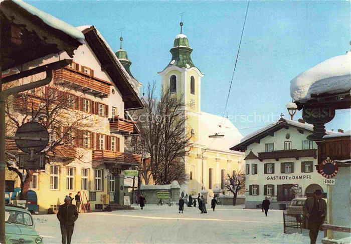 St Johann Tirol AT Kirchturm Dorfplatz Gasthof-zum-Dampfl Winter Schnee Passante