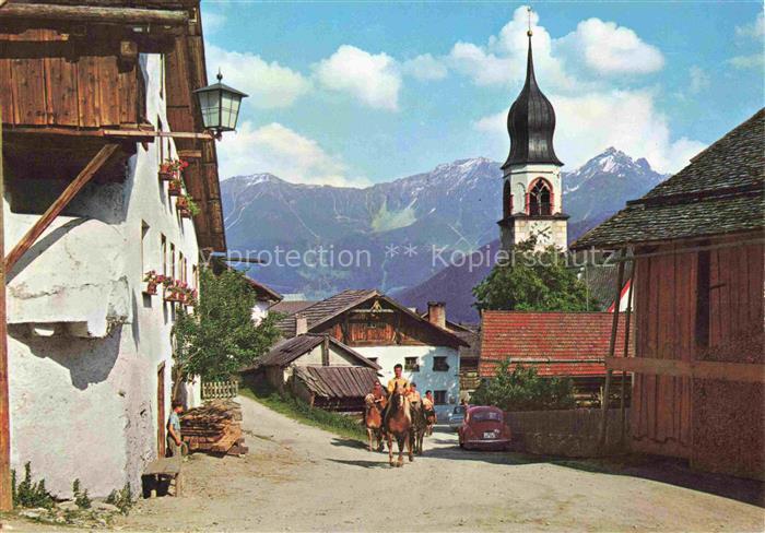 Fiss Oberinntal Tirol AT Dorfstrasse Kirchturm Berge Reiter Bauernhoefe Laterne