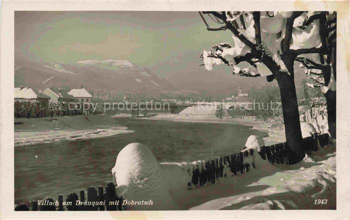 VILLACH Kaernten AT Winterpanorama Partie am Drauquai mit Dobratsch