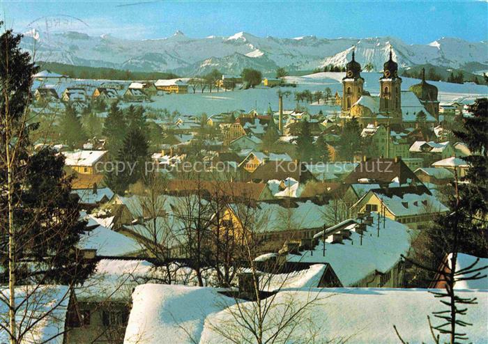 Lindenberg Allgaeu Stadtpanorama mit Kirche Allgaeuer Alpen Winterlandschaft