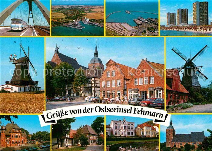Fehmarn Fehmarnsundbruecke Windmuehle Hafen Hotels am Strand Ortsmotiv mit Kirch