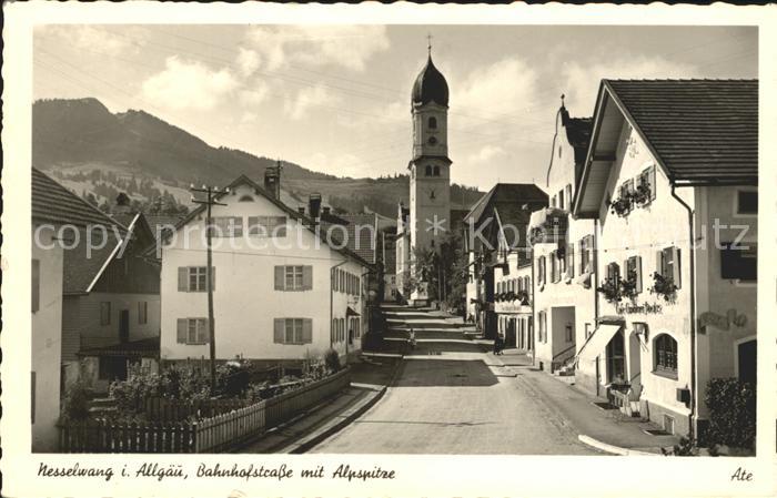 Nesselwang Allgaeu Bayern Bahnhofstrasse mit Kirche und Alpspitze