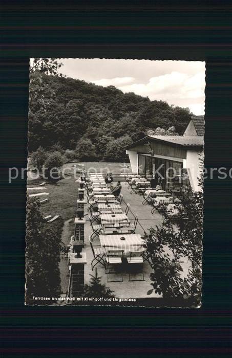 Neuweilnau Gaststaette Erbismuehle Terrasse an der Weil mit Minigolf und Liegewi