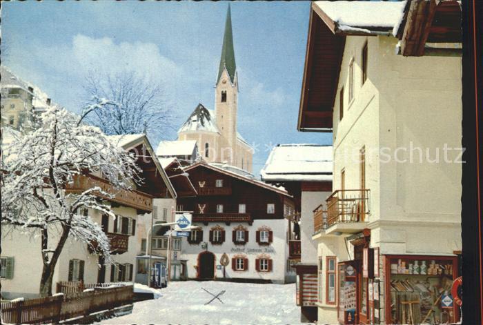 Kirchberg Tirol Ortspartie an der Kirche Gasthof im Winter