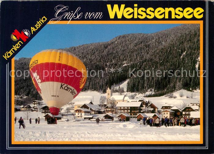 Weissensee Kaernten Winterpanorama mit Heissluftballon
