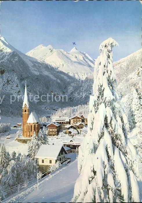 Heiligenblut Kaernten Teilansicht mit Kirche und Grossklockber im Winterkleid