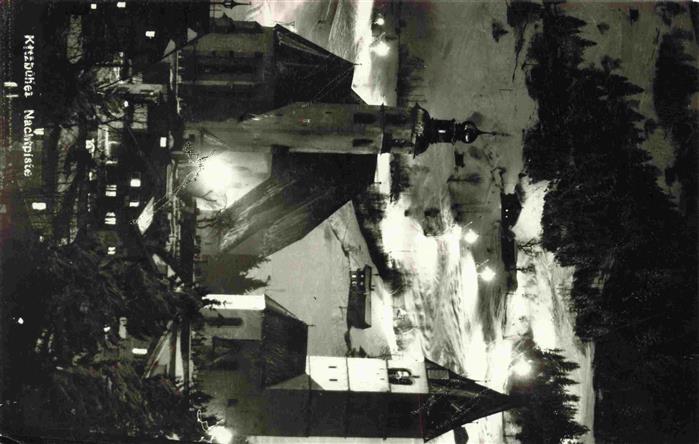 Kitzbuehel Tirol AT Beleuchtete Piste mit Kirche