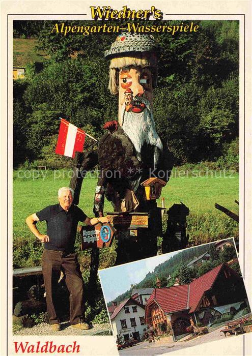 Waldbach Steiermark AT Alpengarten Wasserspiele Holzfigur oesterreich-Fahne Gast