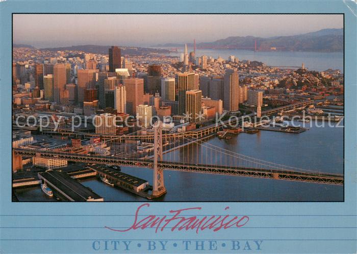 San Francisco California Morning sun lights Oakland Bay Bridge and city skyline