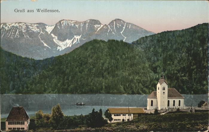 Weissensee Fuessen Ortsansicht mit Kirche Blick auf den Se