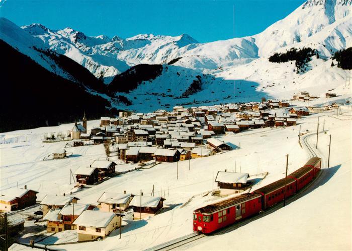Sedrun mit Rueras und Skigebiet von Milez Piz Badus und Eisenbahn